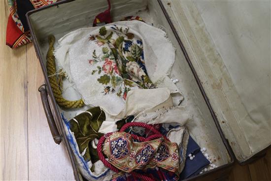 A leather suitcase containing mixed 19th century Berlin beadwork etc